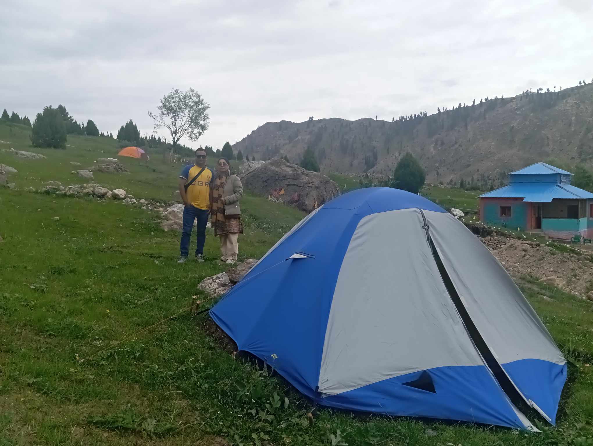 Camping site with tents and mountain backdrop